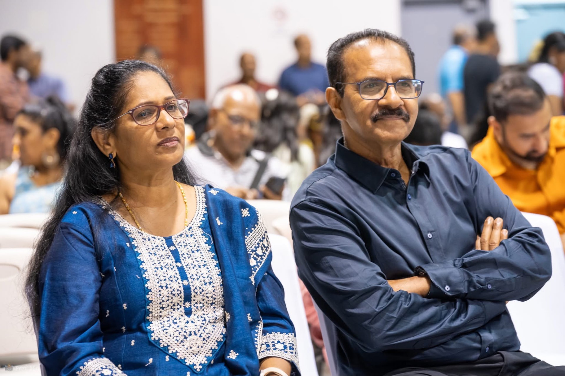 A couple watching a community performance