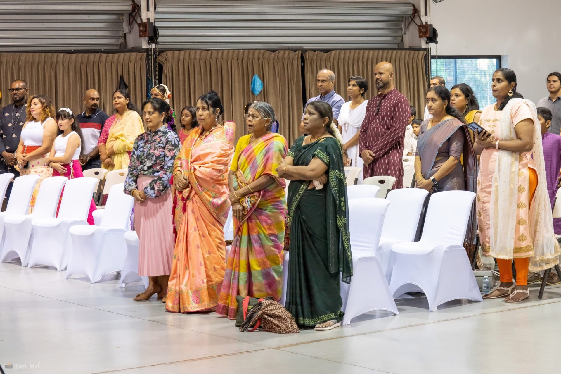 Community members standing during a ceremony