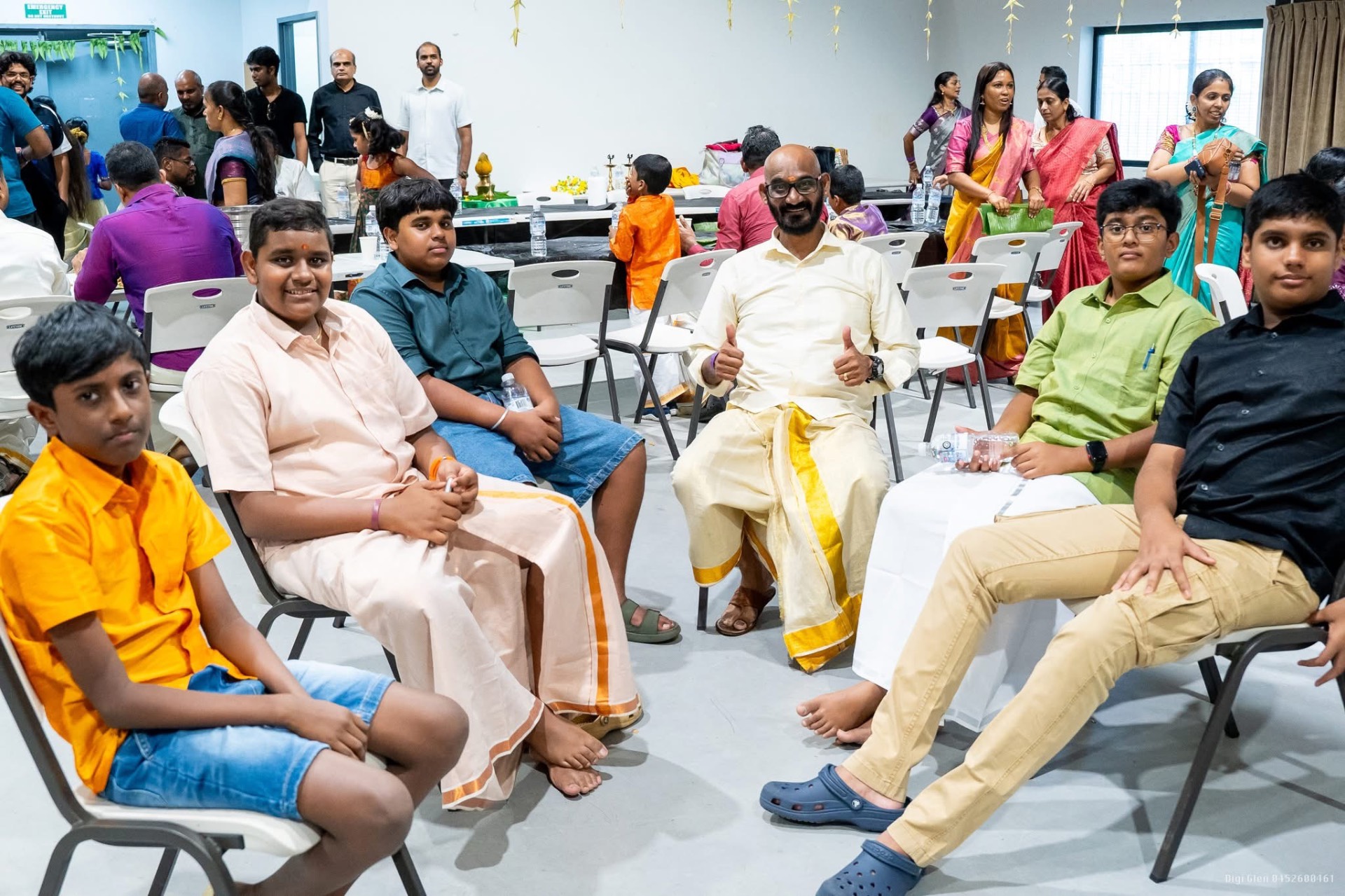 Young boys in traditional veshti at a function