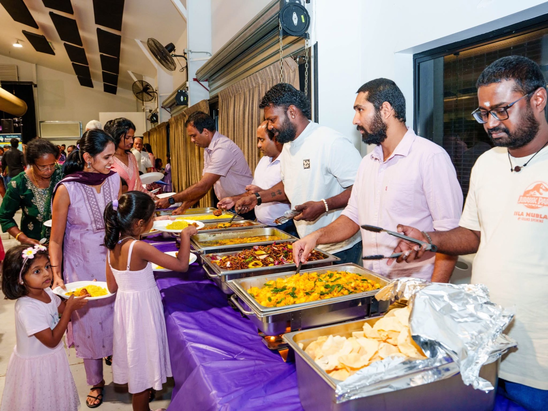 Community buffet line at a Tamil Society NT event