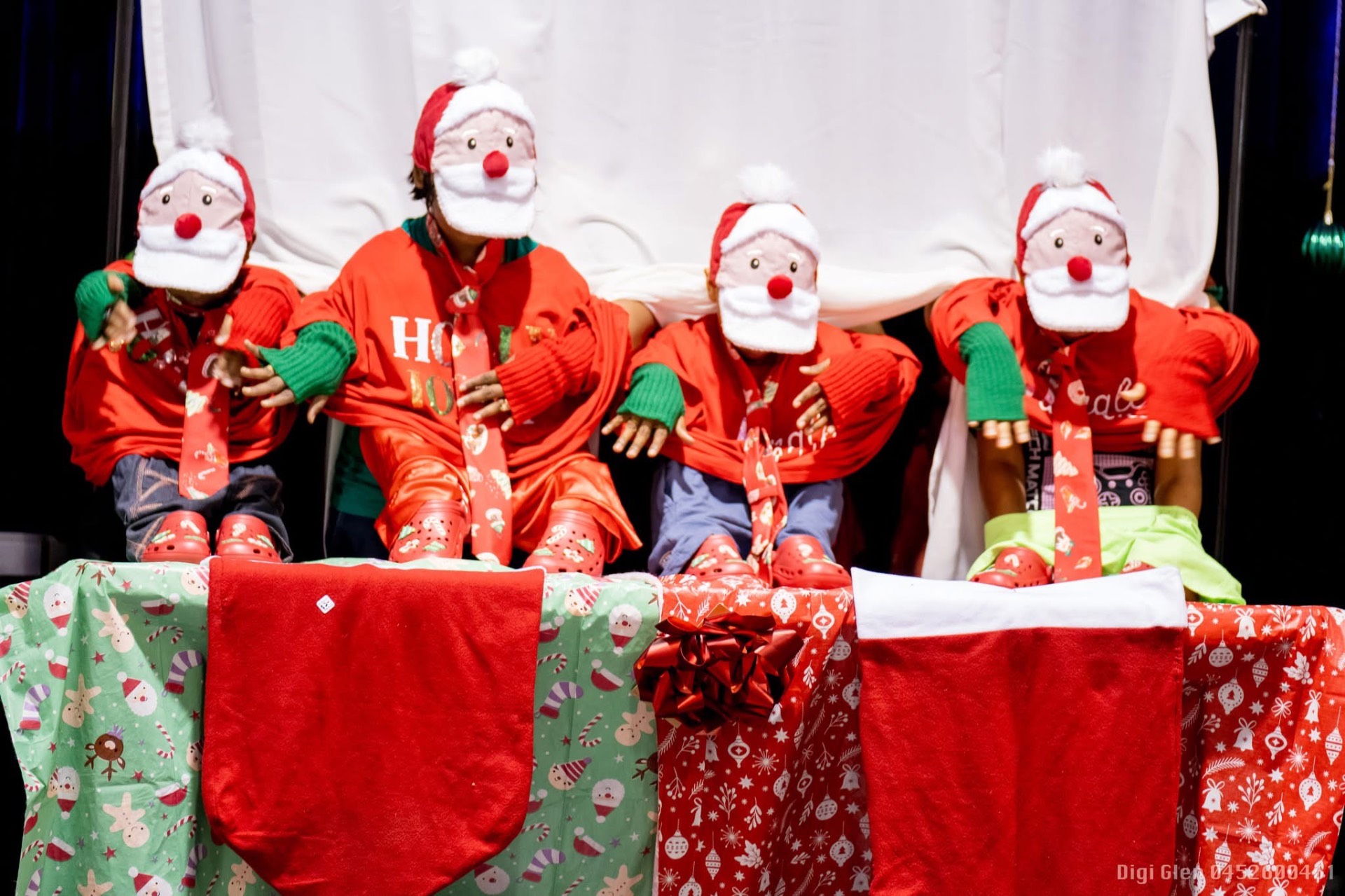 Kids in Santa hats performing at the Christmas show