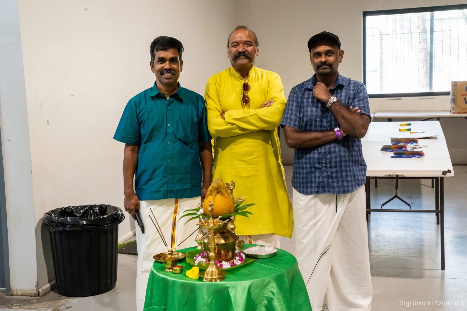 Committee members in traditional veshti at a function