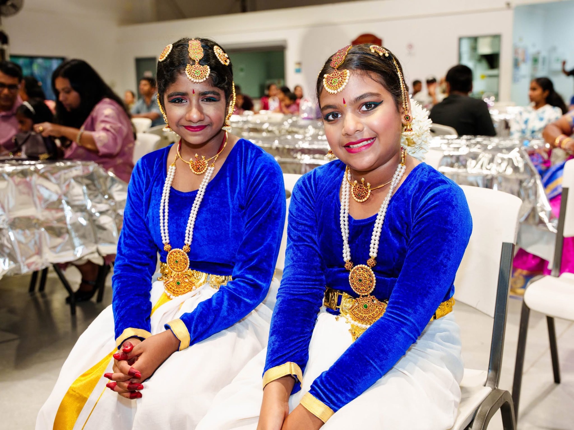 Two young dancers in royal blue costumes