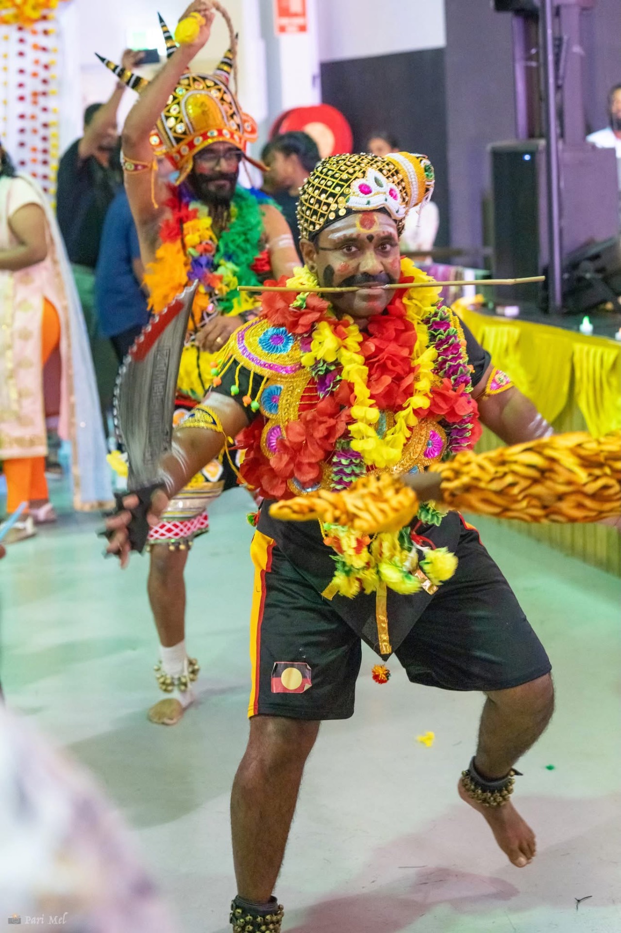 Performers in vibrant folk costumes mid-dance