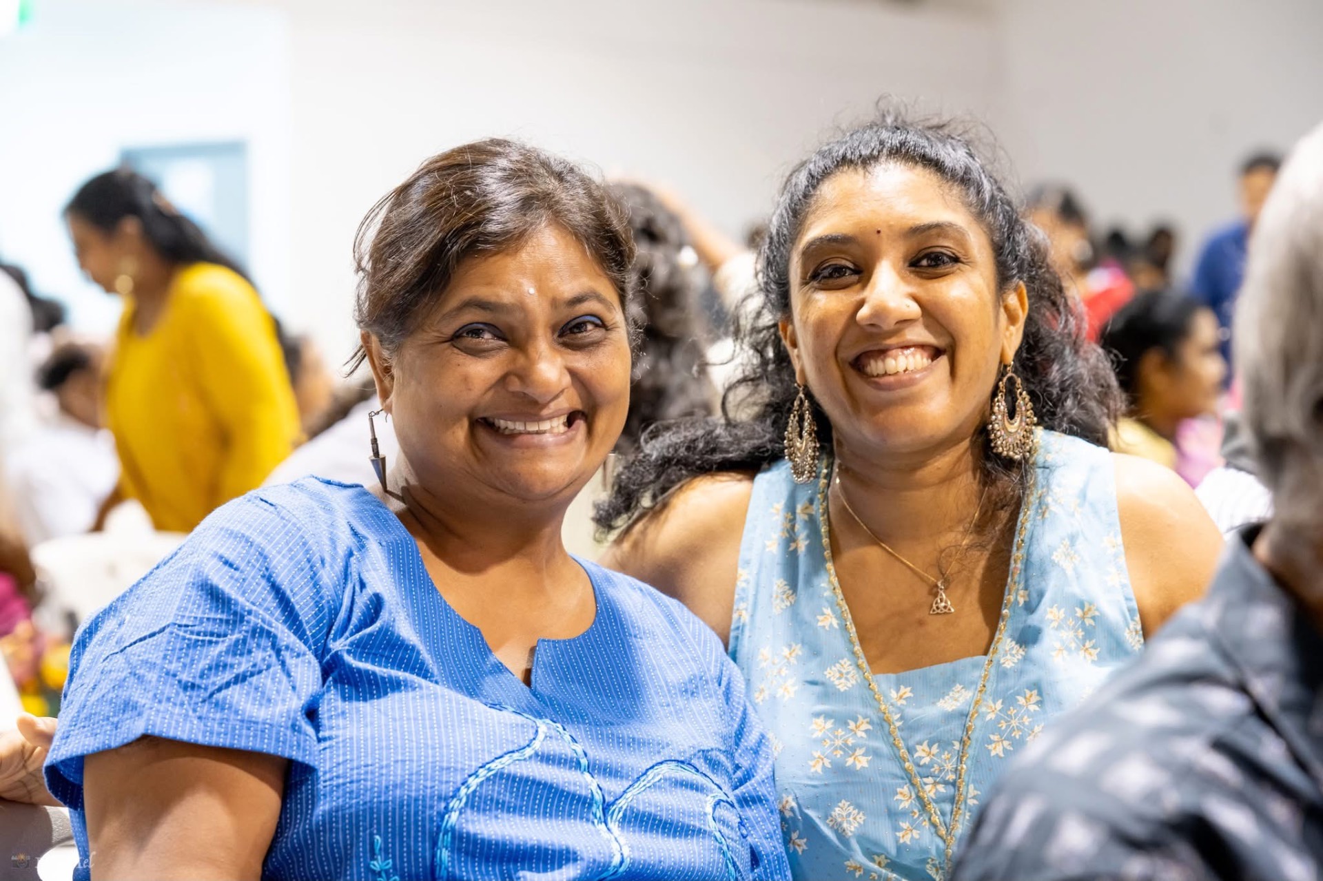 Friends sharing a joyful moment at a community event