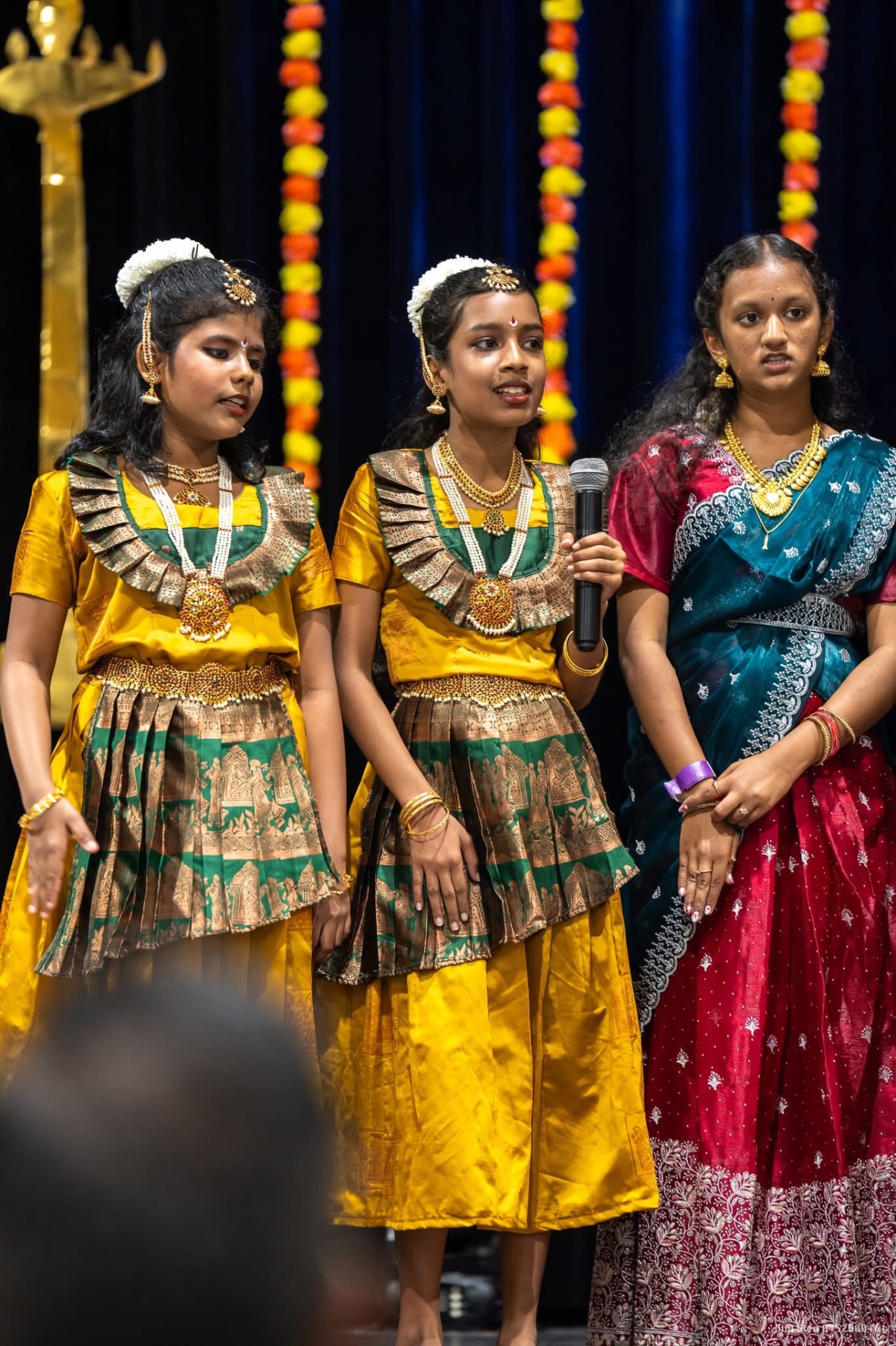 Girls in matching costumes performing on stage