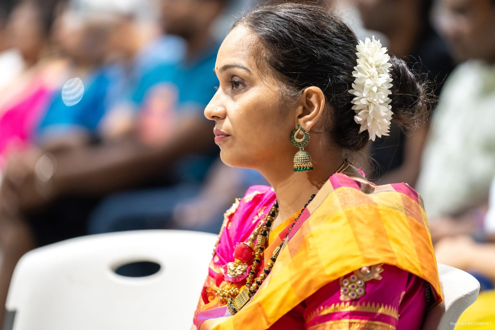 Community member with jasmine flowers in her hair