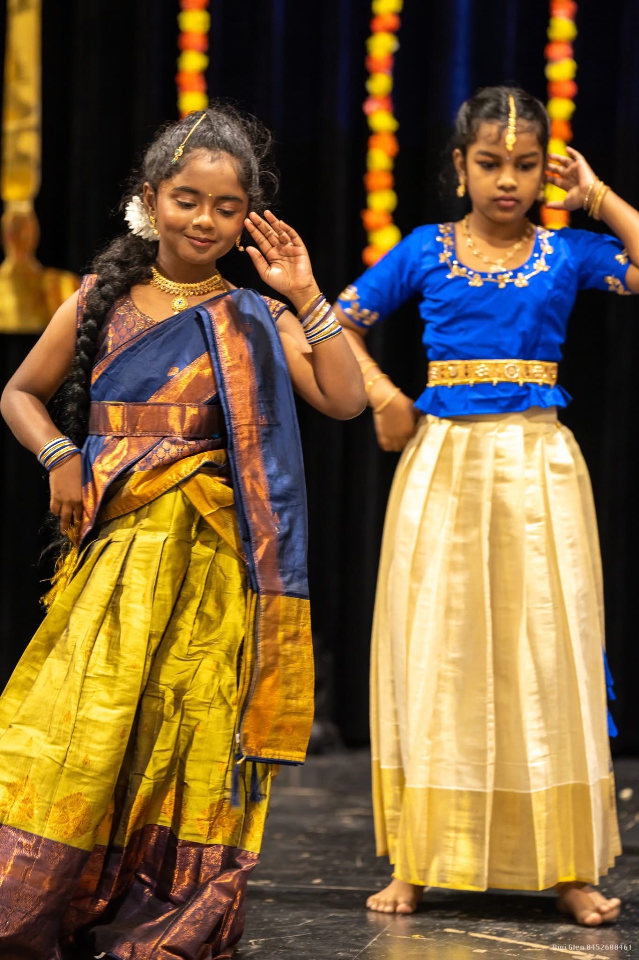 Young dancers in traditional half-saree on stage