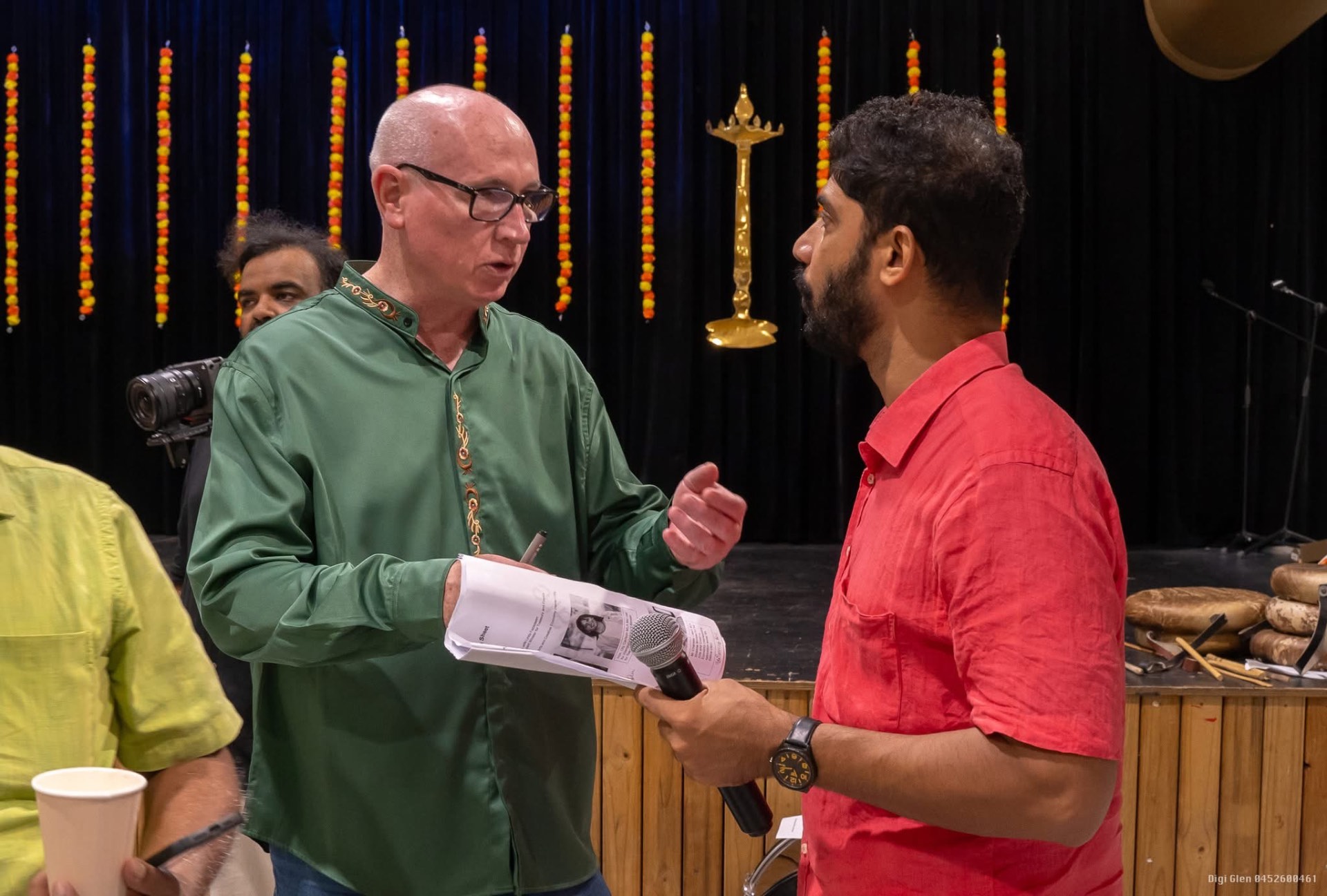 MC and committee member on stage at an event
