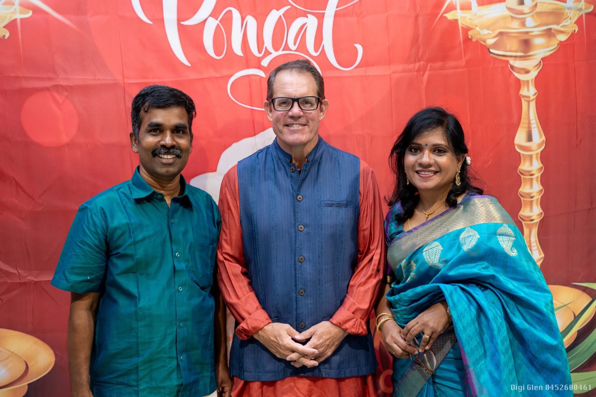 Three guests in front of the Pongal backdrop