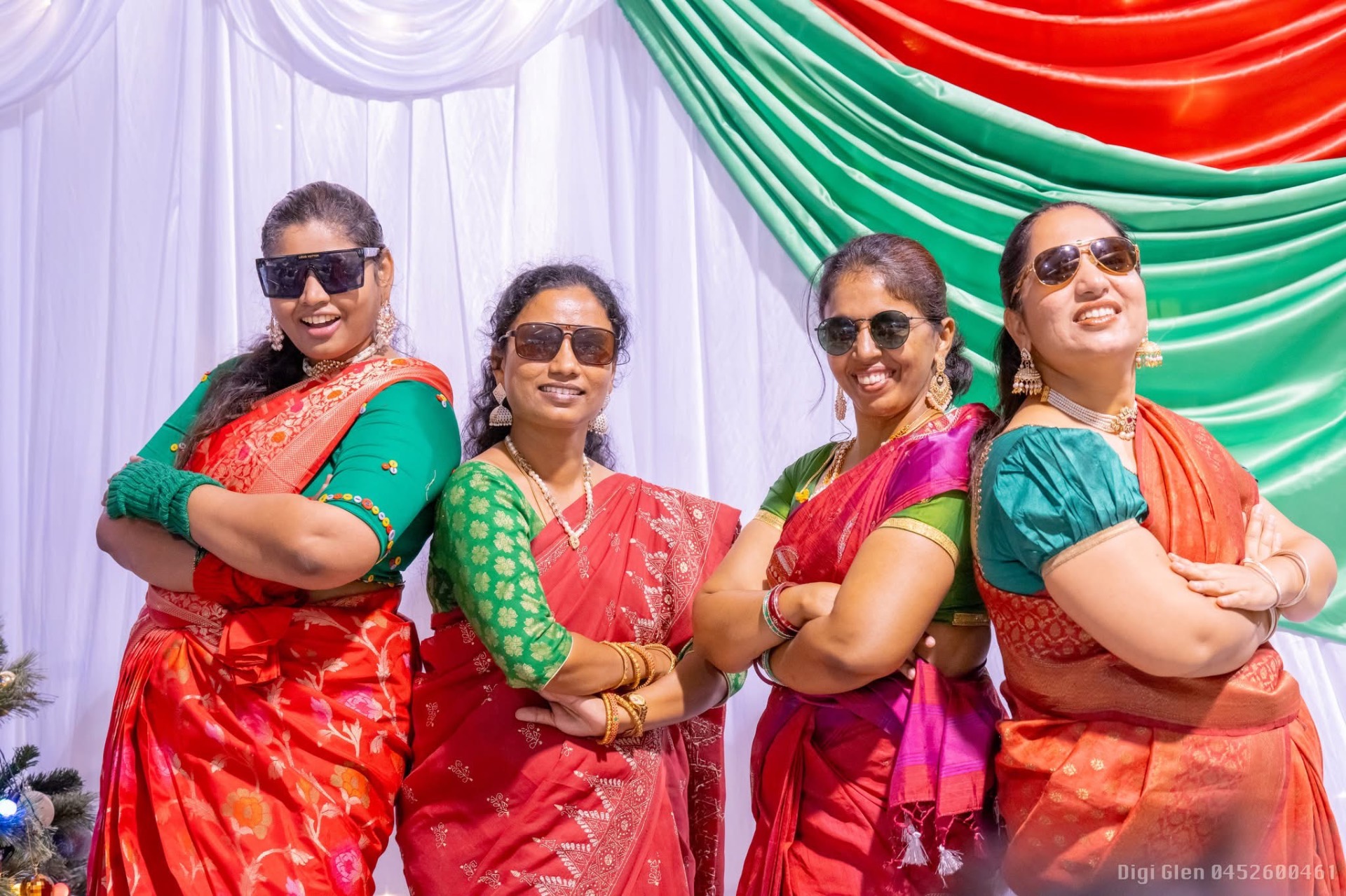 Group of women in red sarees posing together